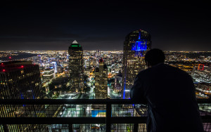 Overlooking downtown Dallas at night from a rooftop.