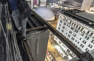 Walking on a beam while rooftopping in Hong Kong