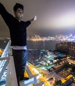 Standing on a giant neon at night; taken while rooftopping in Hong Kong