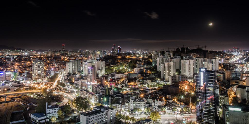 A photo overlooking the skyline of Seoul taken while rooftopping at night. 