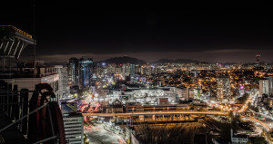 A photo overlooking the skyline of Seoul taken while rooftopping at night.