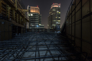 Navigating a metal maze on the top of a construction site at night