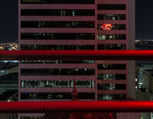 Building at night with 2 bars in the image; taken while rooftopping in Dallas