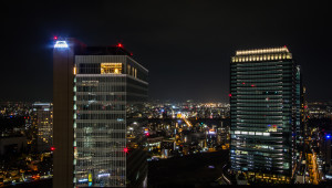 Twin buildings pictured at night; taken rooftopping in Osaka, Japan