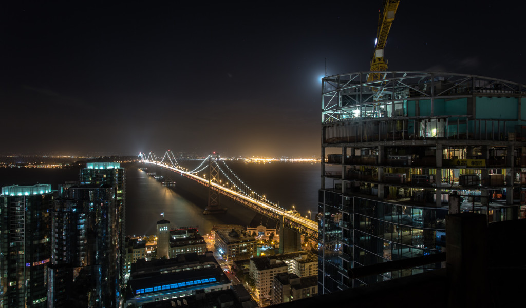 The Bay Bridge at night while rooftopping in San Francisco