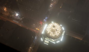Looking down on an illuminated dome at night, while rooftopping in San Francisco